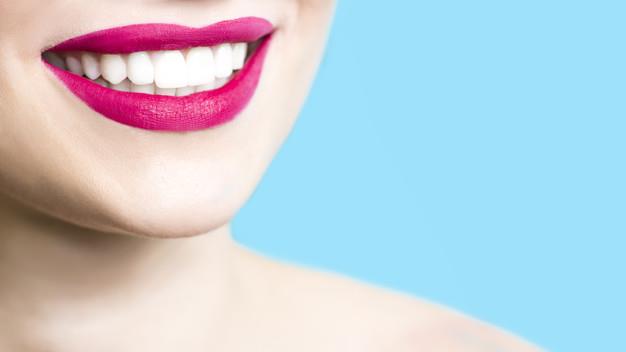 close-up-of-a-smiling-woman-with-healthy-white-teeth-red-lipstick-clean-skin_8119-1979
